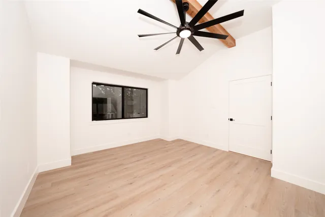 a view of an empty room with wooden floor
