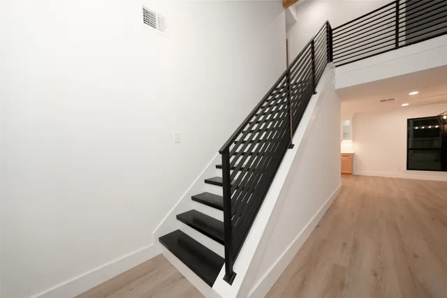 a view of entryway and hall with wooden floor