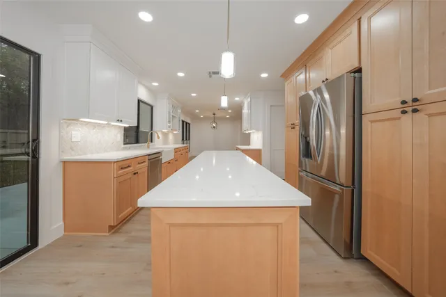 a kitchen with a stove cabinets and wooden floor