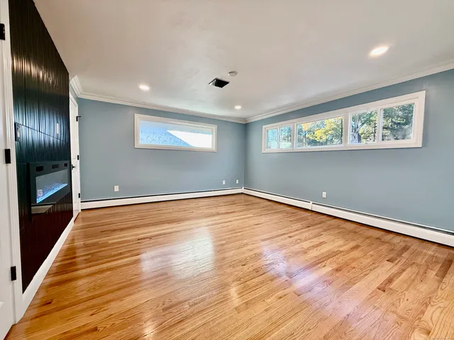 wooden floor in an empty room with a window