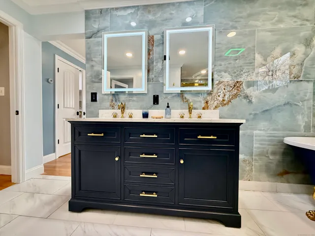a bathroom with a sink vanity and mirror