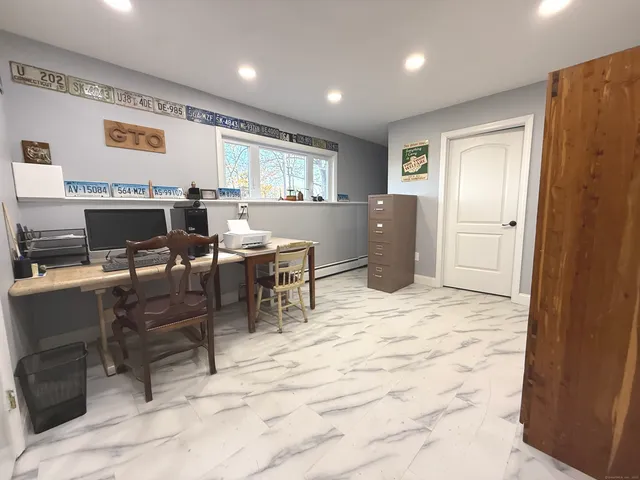 a room with a washing machine and a toilet