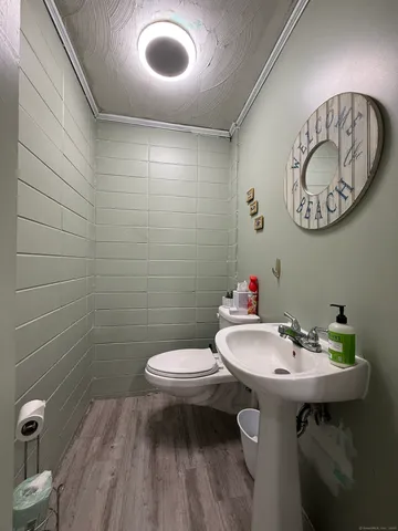 a kitchen with stainless steel appliances a table chairs stove and refrigerator