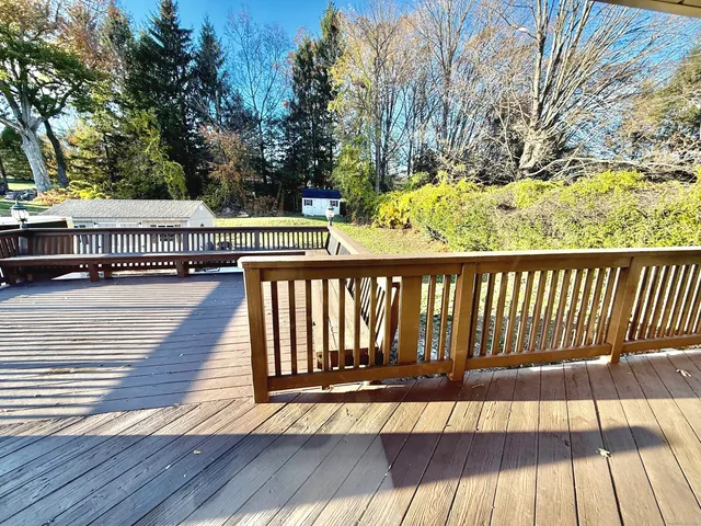 a view of balcony with wooden floor and fence