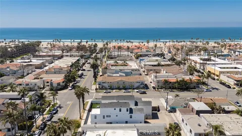 a view of multiple house with palm trees
