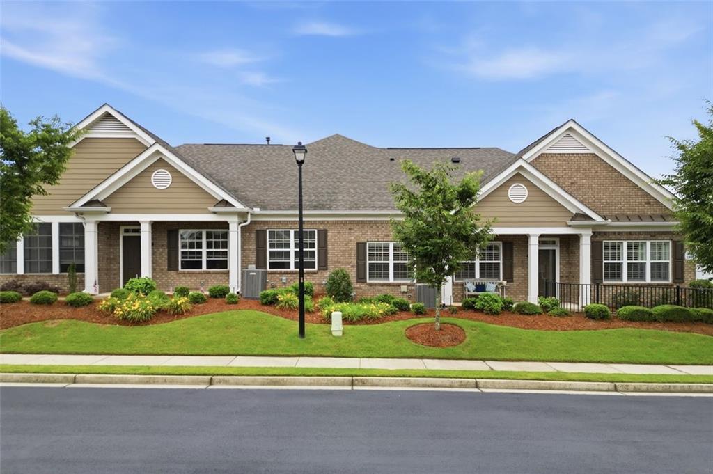 3328 Ivy Ridge Court Buford, GA 30519 - Photo 2 of 34 a front view of a house with a yard table and chairs
