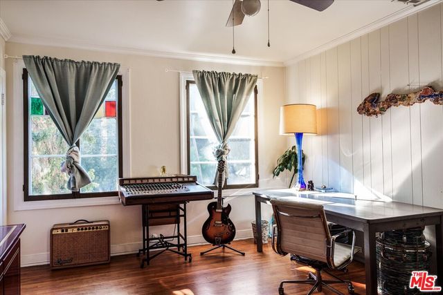 a view of backyard with a deck and a large tree