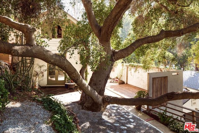a room with a black white checkered floor and a fireplace