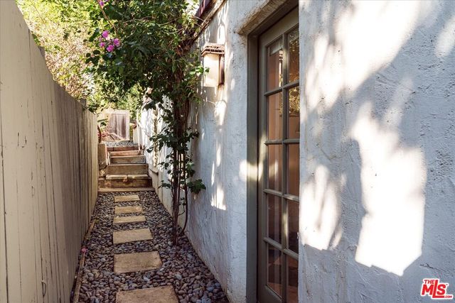 a bathroom with a sink shower and a mirror