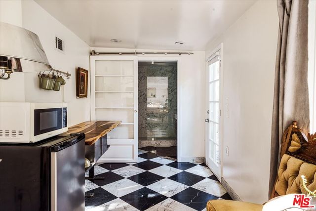 a view of a chairs and tables in patio of a house