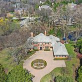 an aerial view of a house with yard swimming pool and outdoor seating