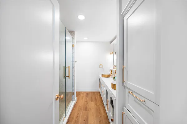 a bathroom with a tub sink and glass door