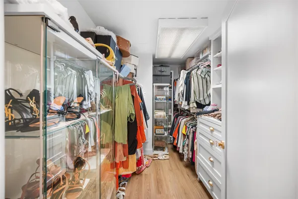 a bathroom with a granite countertop sink a toilet a mirror and shower