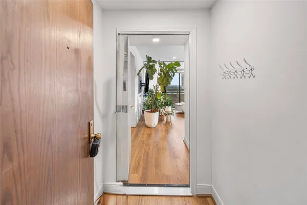 a living room with furniture a potted plant and a flat screen tv