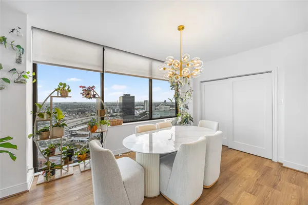 a white bath tub sitting next to a white vase with flowers