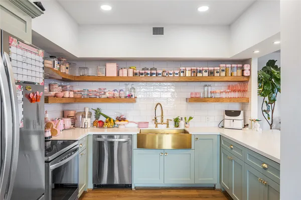 a kitchen with refrigerator and cabinets