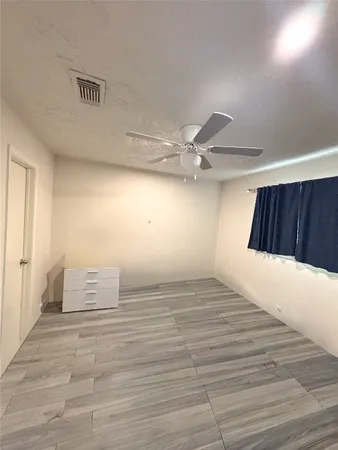 a view of an empty room and wooden floor