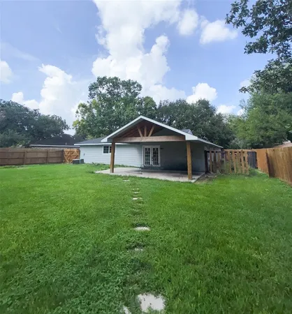 a front view of house with backyard and green space