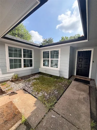 front view of a house with a window and balcony