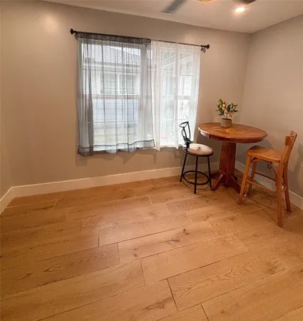 a dining room with furniture and a window