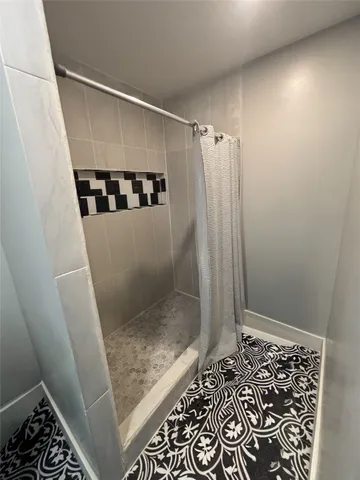 a bathroom with a shower and a toilet