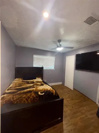 a bedroom with a bed and a view of kitchen