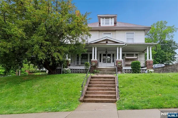 a view of a house with garden and porch