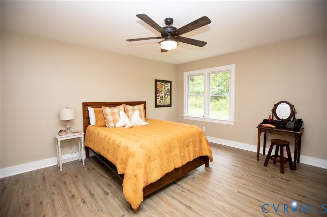 3153 West 3rd Street Farmville, VA 23901 - Photo 28 of 63 a bedroom with a bed a window and a chandelier