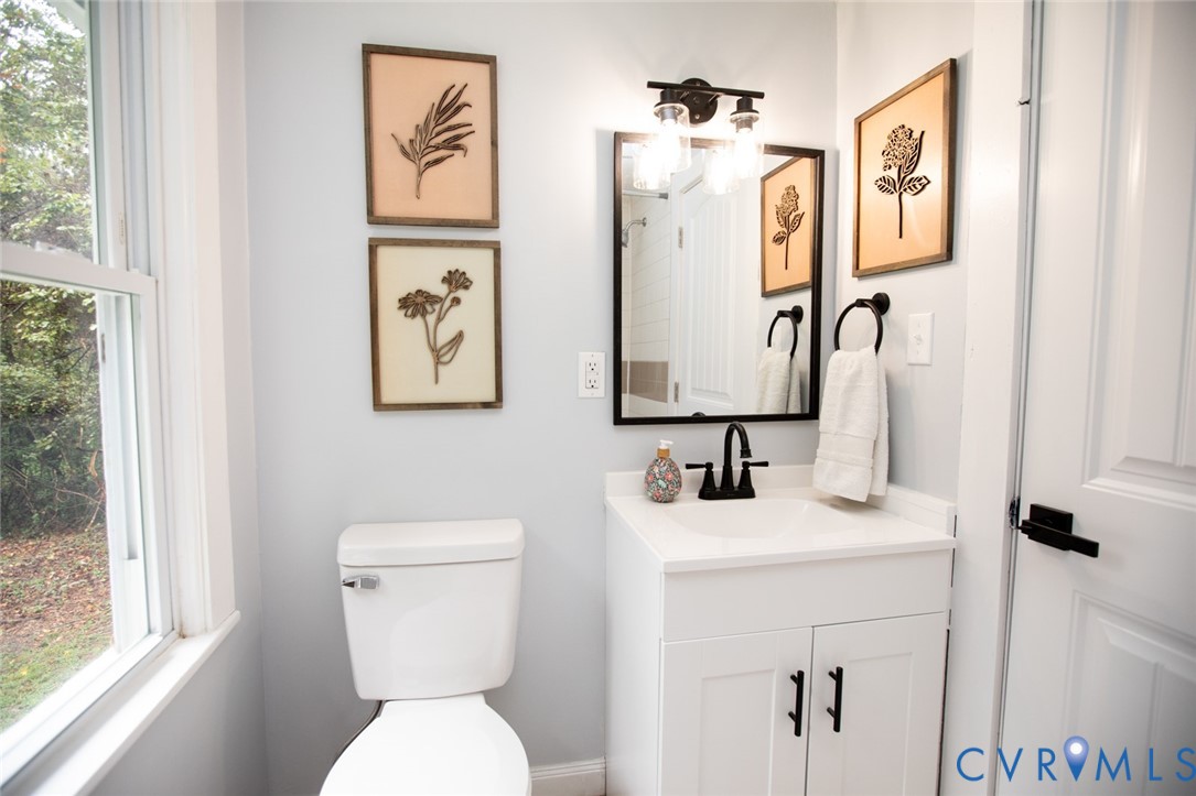 3153 West 3rd Street Farmville, VA 23901 - Photo 49 of 63 a bathroom with a toilet sink and mirror
