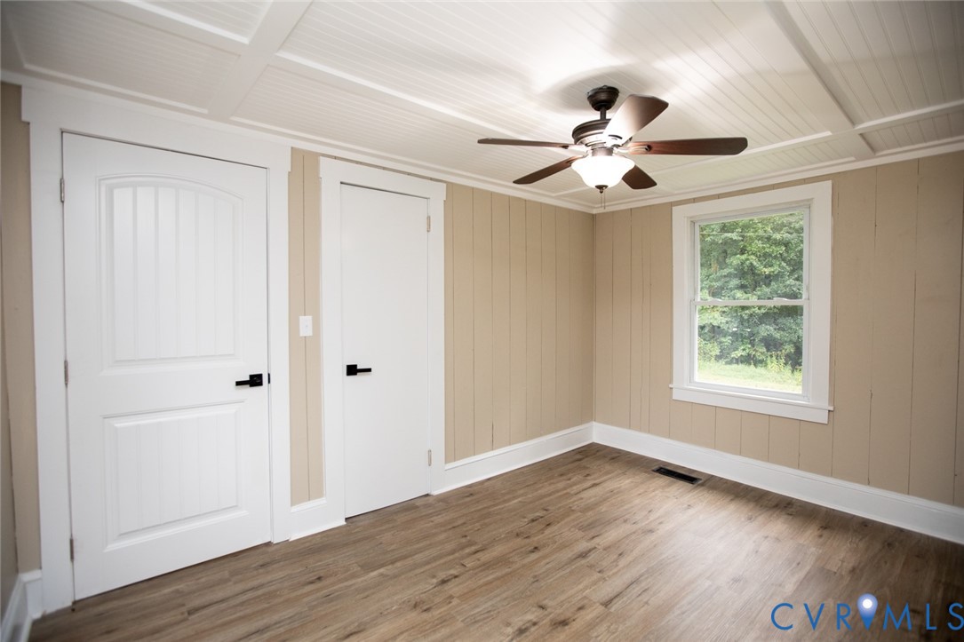 3153 West 3rd Street Farmville, VA 23901 - Photo 55 of 63 an empty room with wooden floor ceiling fan and windows