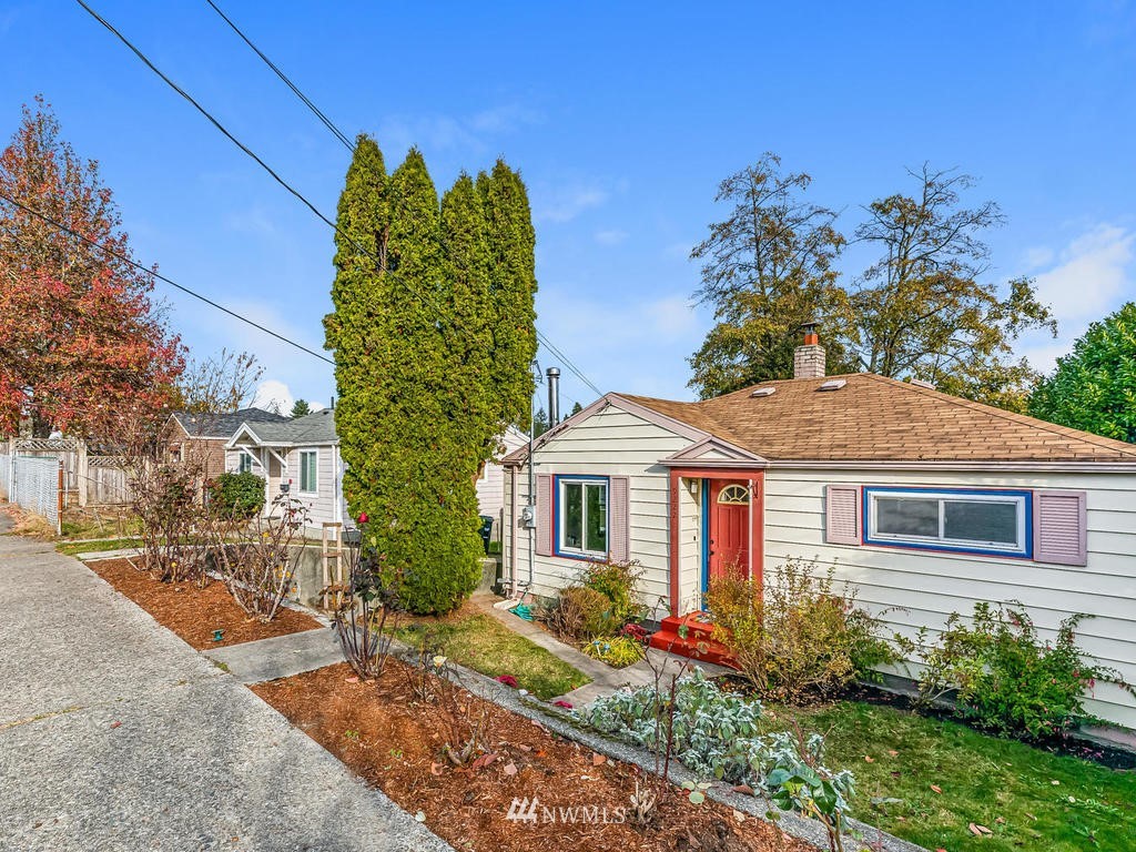 9222 12th Avenue Southwest Seattle, WA 98106 - Photo 2 of 30 a front view of a house with a garden