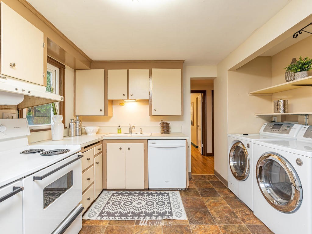 9222 12th Avenue Southwest Seattle, WA 98106 - Photo 11 of 30 a kitchen with a stove top oven sink and cabinets