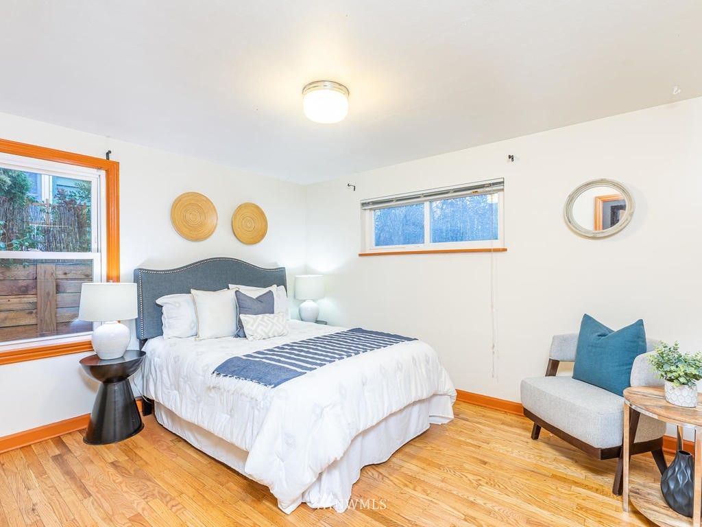 9222 12th Avenue Southwest Seattle, WA 98106 - Photo 12 of 30 a bedroom with a bed and wooden floor