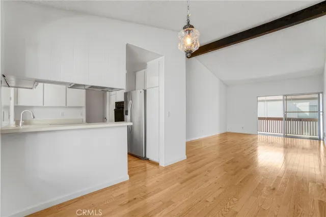 a kitchen with a refrigerator and a sink