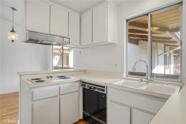 a kitchen with stainless steel appliances granite countertop a refrigerator and a stove