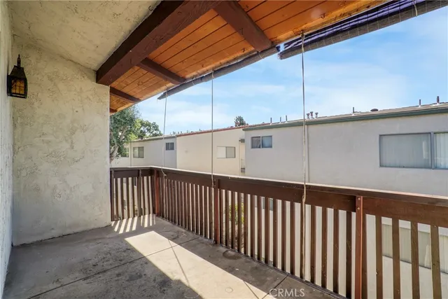 a view of a hallway with wooden floor and entryway