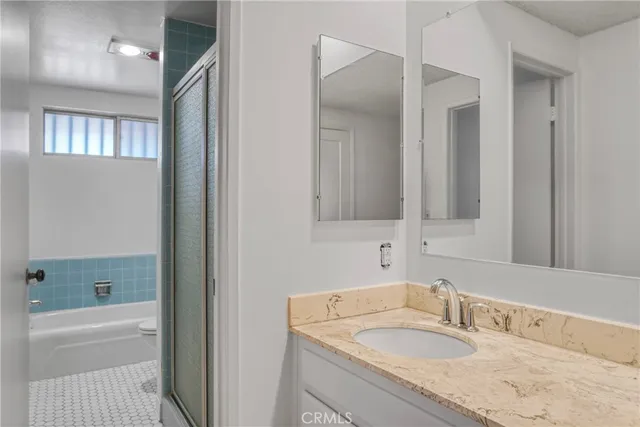 a bathroom with a bathtub and shower