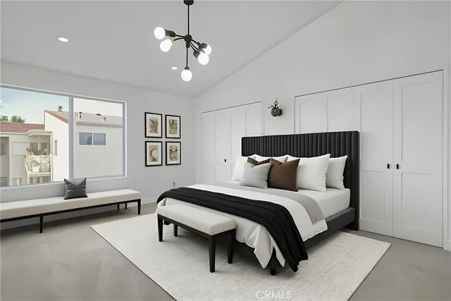 a bedroom with a bed couch and window