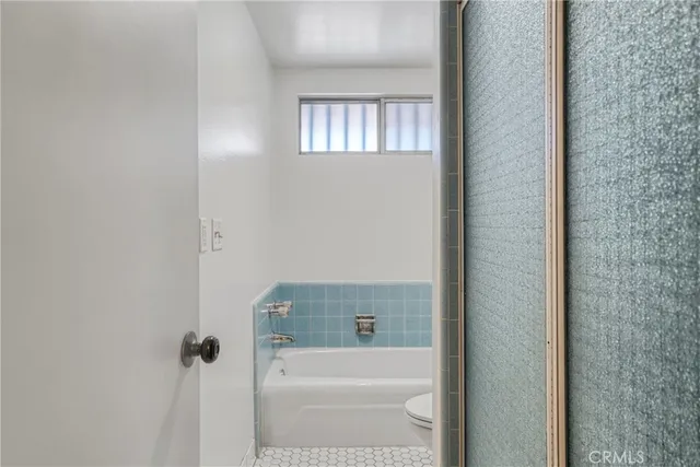 a bathroom with a bathtub and window