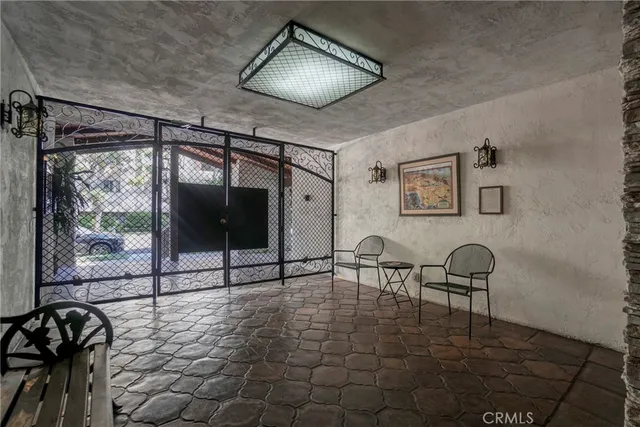 a hallway with a door and a chair