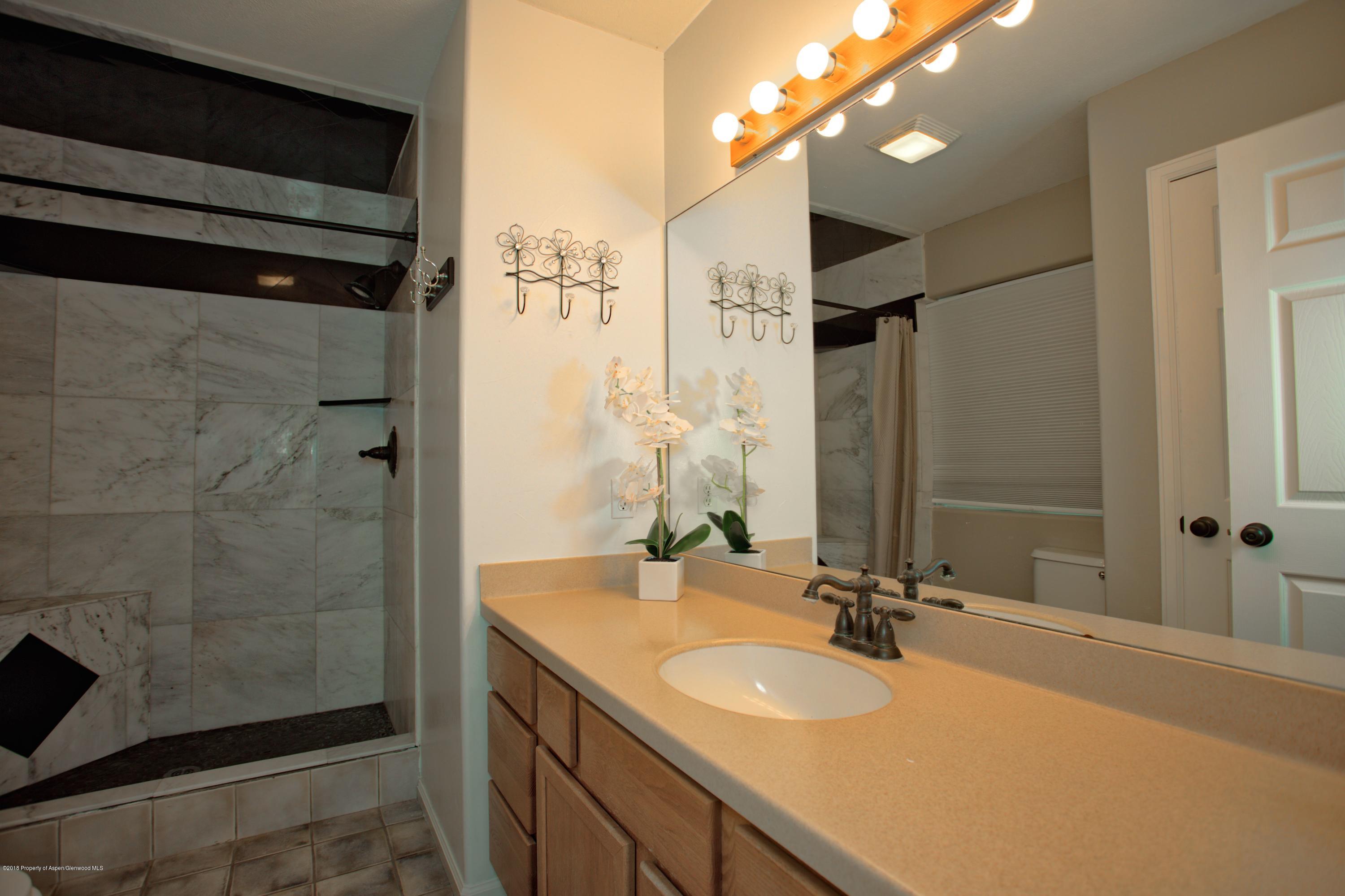 841 Hickory Drive Rifle, CO 81650 - Photo 11 of 20 a bathroom with a sink and a mirror