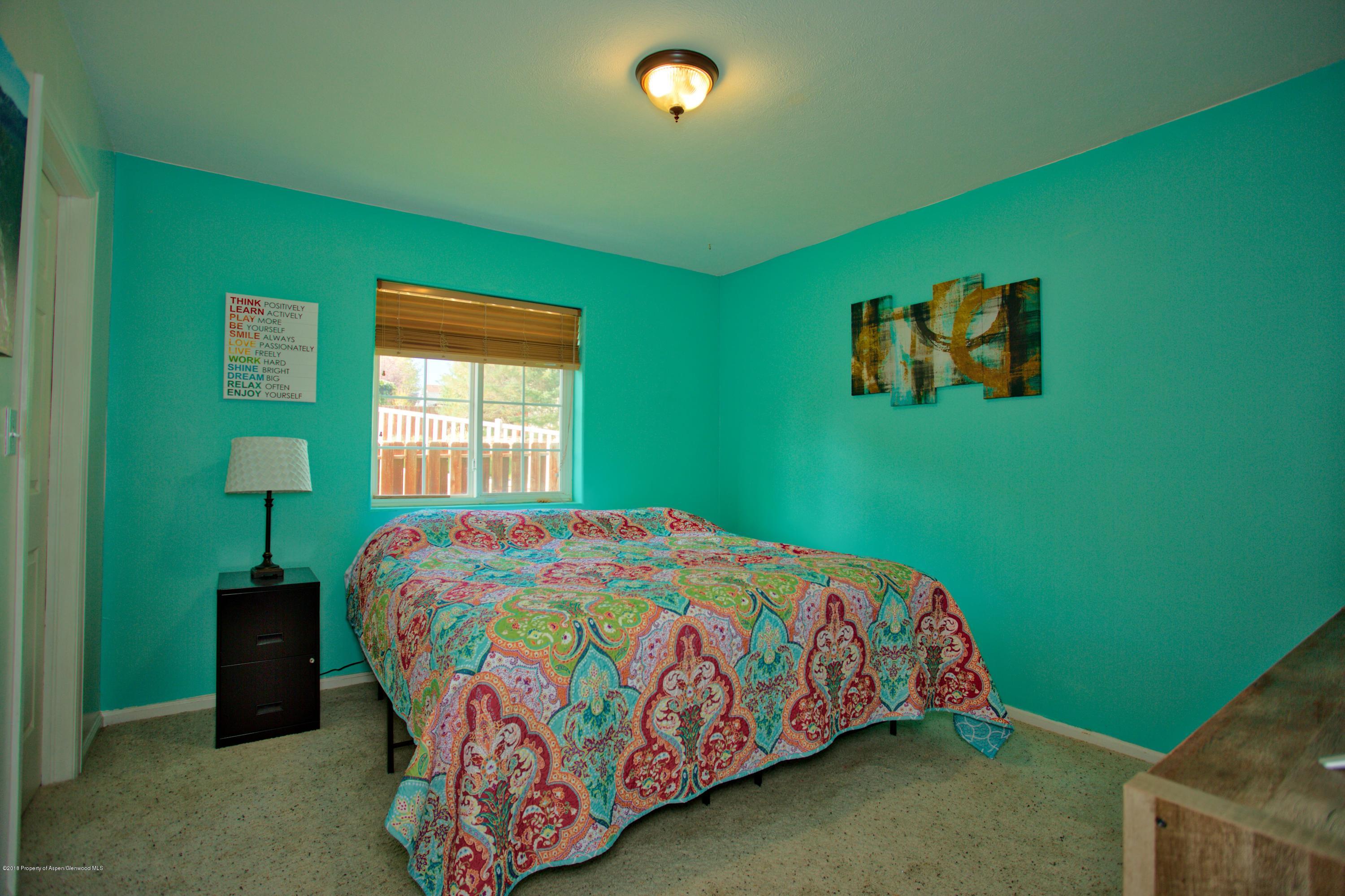 841 Hickory Drive Rifle, CO 81650 - Photo 13 of 20 a bedroom with a bed and a window