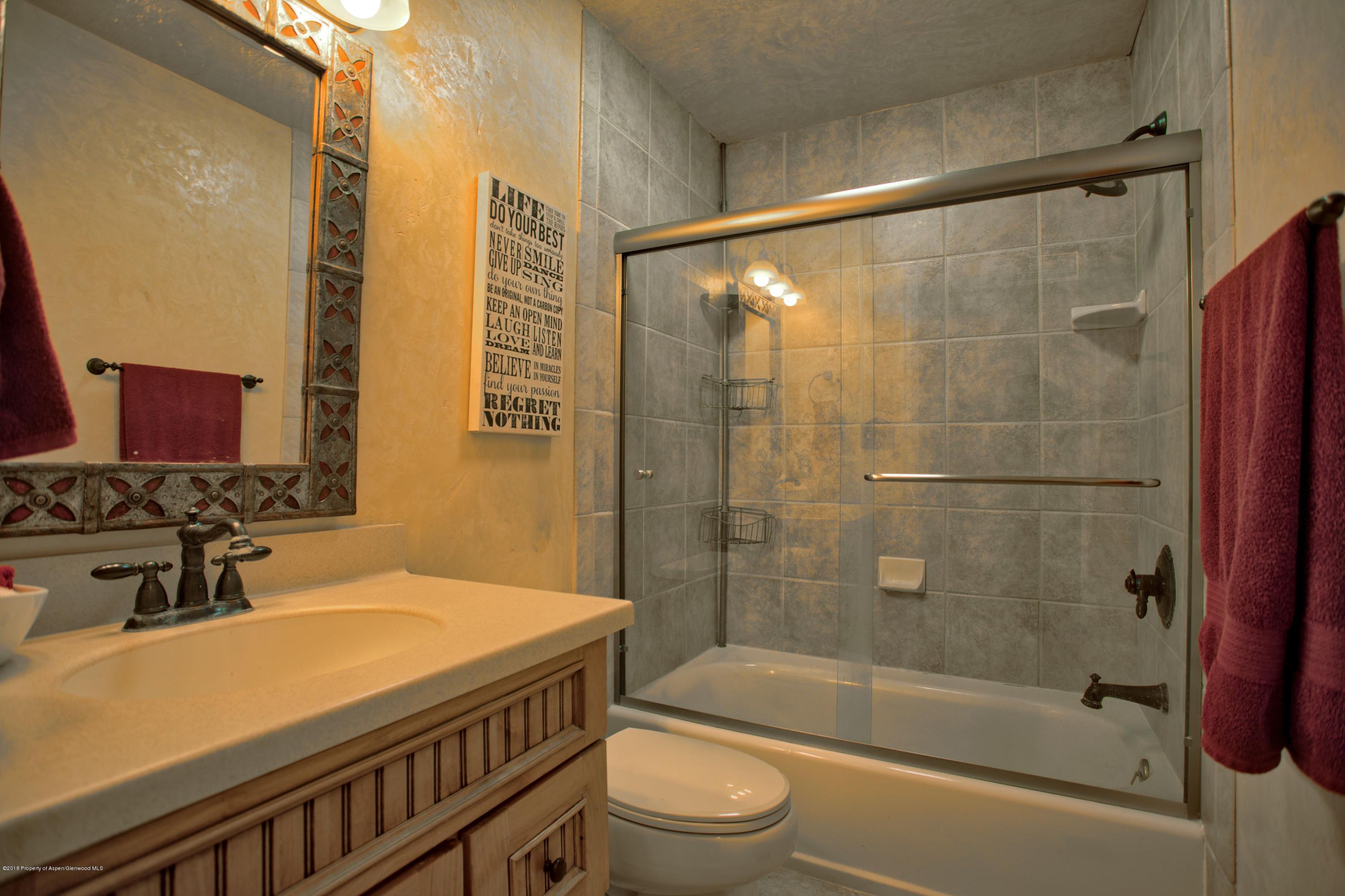 841 Hickory Drive Rifle, CO 81650 - Photo 14 of 20 a bathroom with a sink a toilet and shower