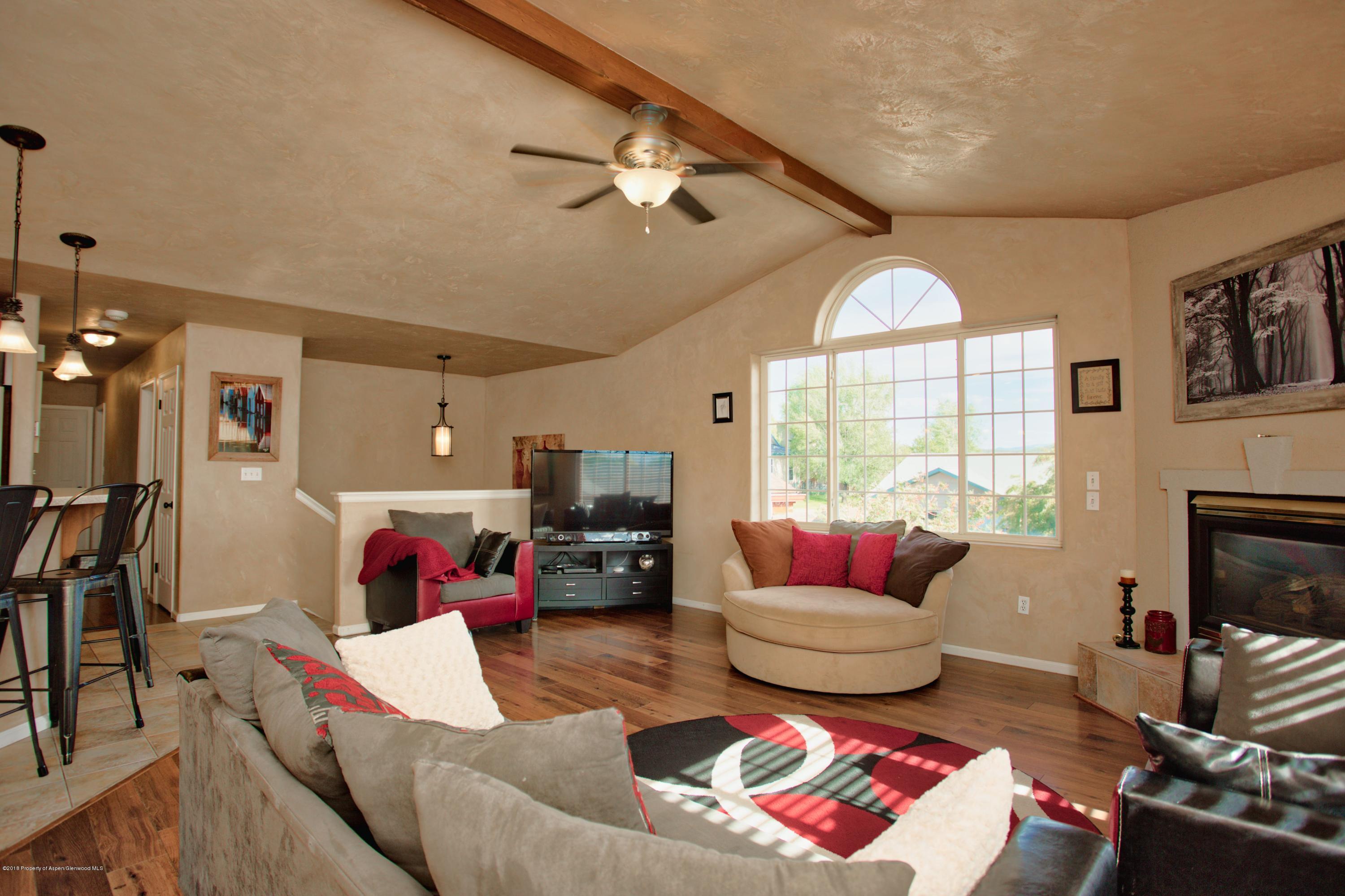 841 Hickory Drive Rifle, CO 81650 - Photo 5 of 20 a living room with furniture fireplace and a large window