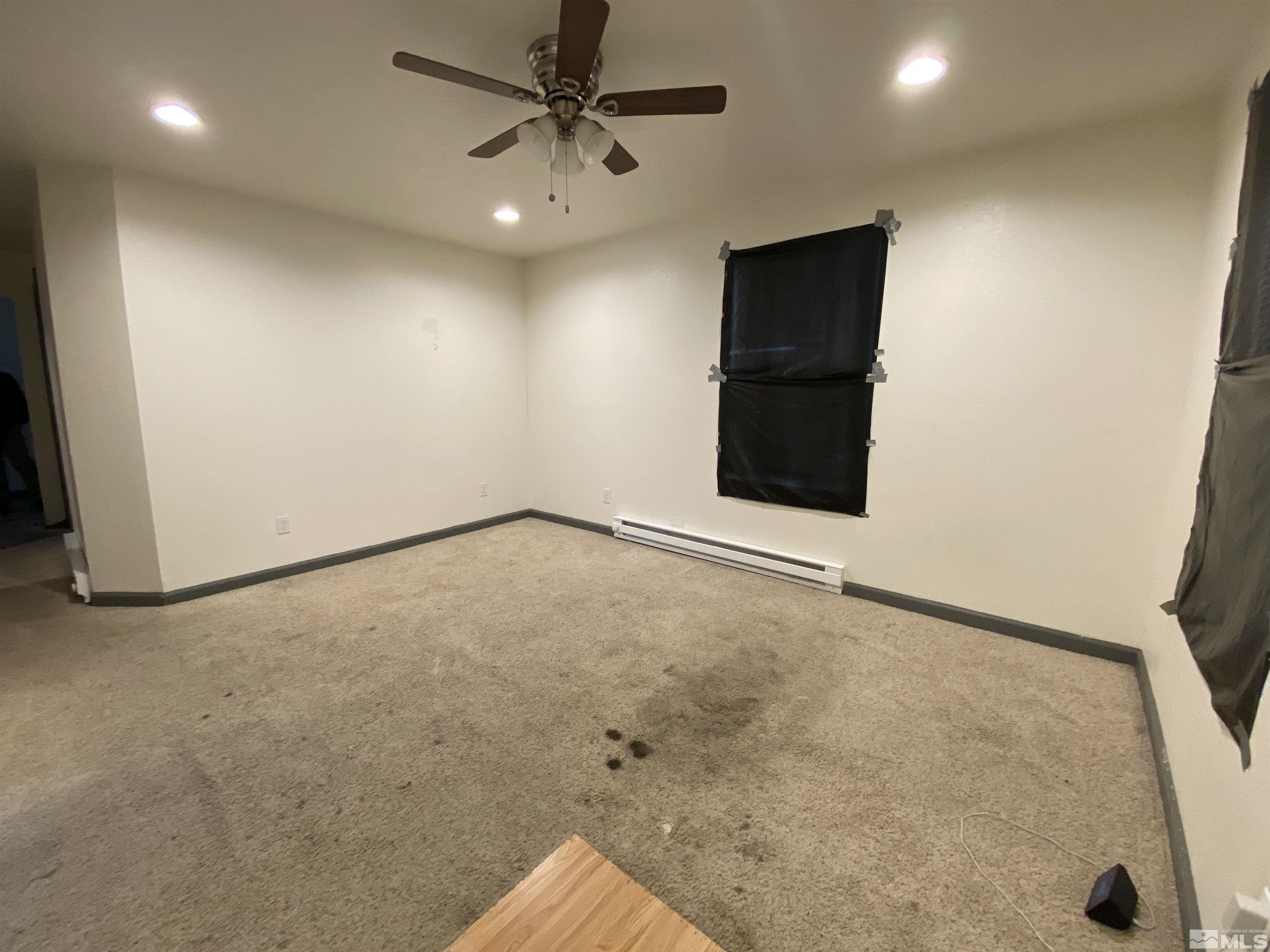 656 Spokane Street Reno, NV 89512 - Photo 18 of 31 an empty room with a ceiling fan and entryway