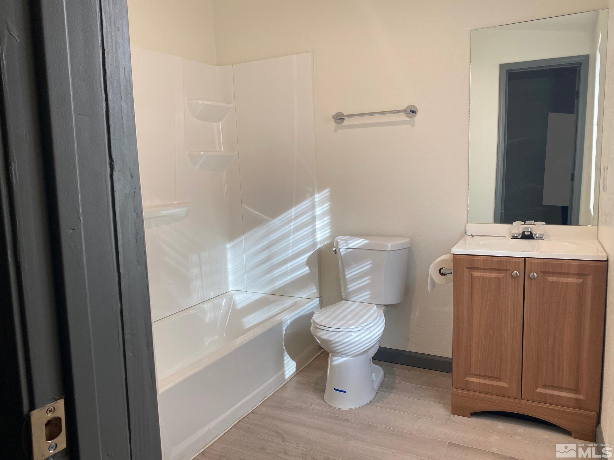 656 Spokane Street Reno, NV 89512 - Photo 23 of 31 a white toilet sitting next to a bathroom sink