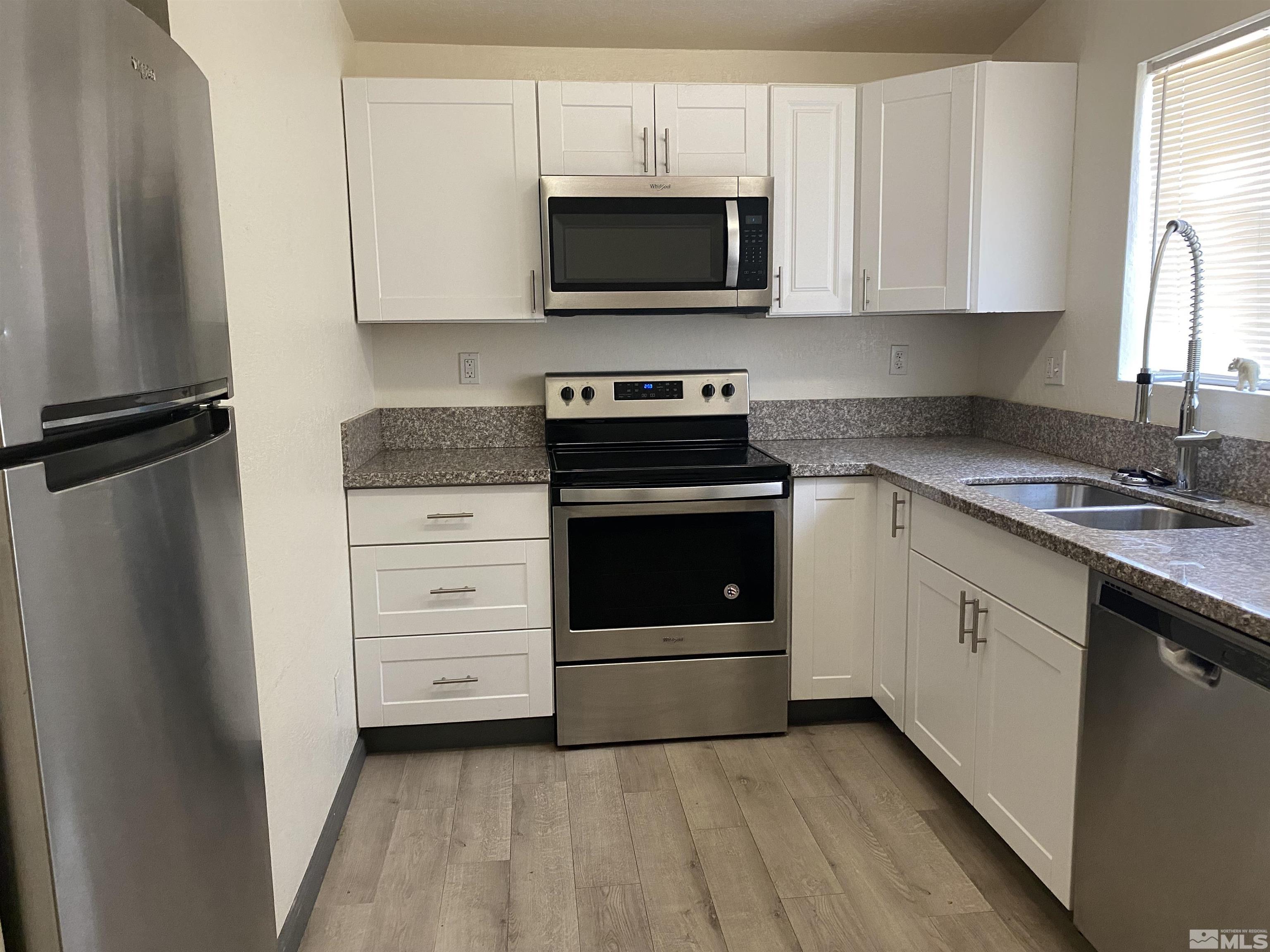 656 Spokane Street Reno, NV 89512 - Photo 3 of 31 a kitchen with a stove and a microwave