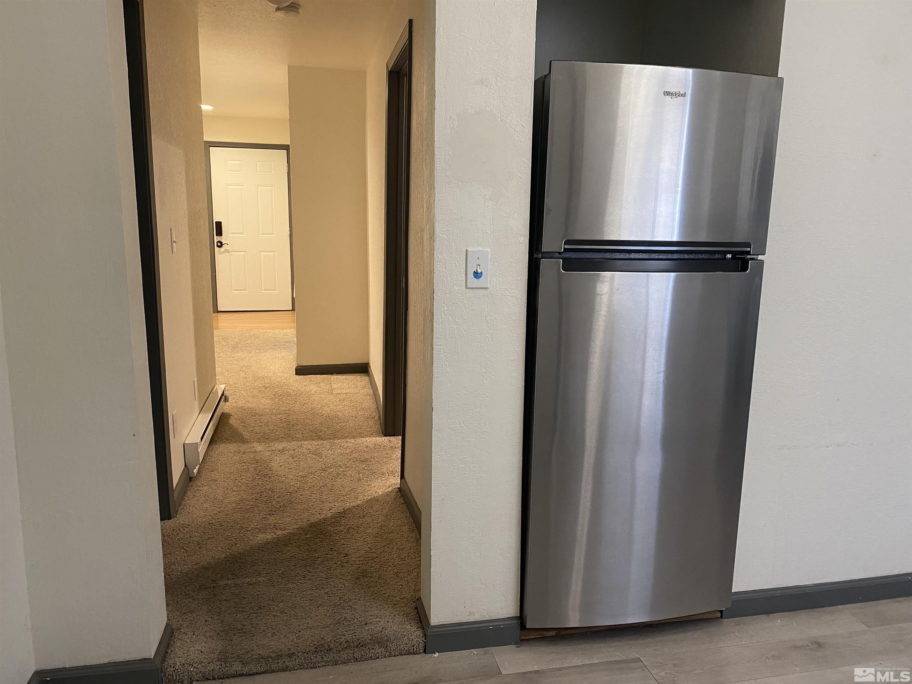 656 Spokane Street Reno, NV 89512 - Photo 6 of 31 a view of a refrigerator in kitchen and an empty room