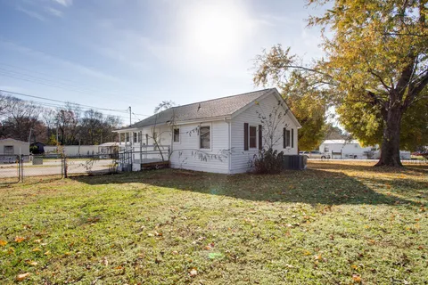 a view of a house with swimming pool and sitting area