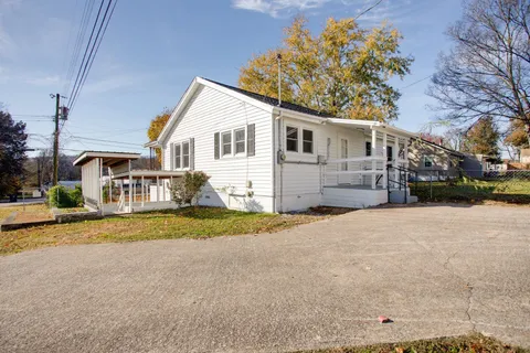 a view of a house with a yard covered with snow